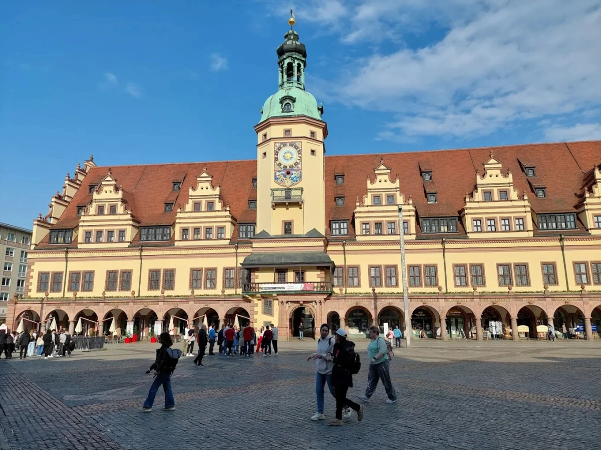 Leipzig Üniversitesi Eski Belediye Binası ve Pazar Meydanı Manzarası Leipzig Üniversitesi ziyaretinde mutlaka görülmesi gereken yerlerden biri olan tarihi Eski Belediye Binası, şehrin kalbi olan pazar meydanında yer alıyor. Kırmızı çatısı, tarihi saat kulesi ve etkileyici mimarisiyle Leipzig Üniversitesi çevresindeki kültürel dokuyu en iyi yansıtan yapılardan biri olarak öne çıkıyor. Mimarisi ve tarihi atmosferiyle ziyaretçilerine unutulmaz bir deneyim sunan bu yapı, fotoğraf tutkunları için de harika kareler yakalama imkanı sağlıyor.